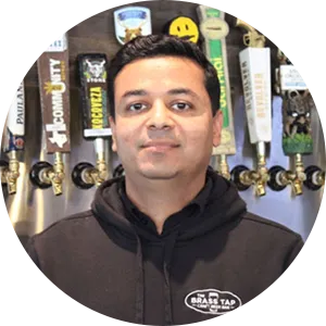 Sid Patel standing inside a Brass Tap Social House and Kitchen restaurant